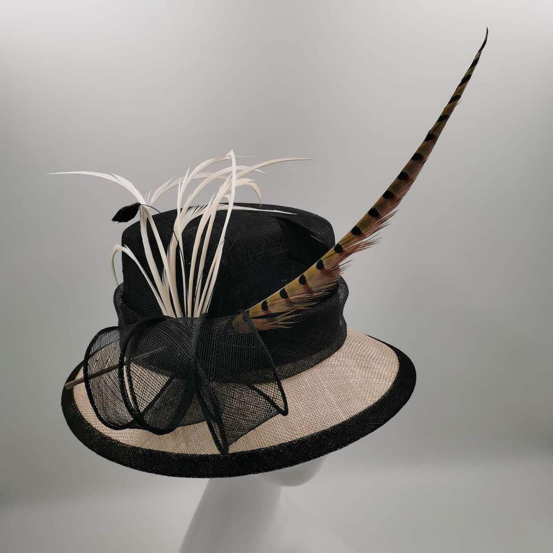 Beige medium brim hat with black trim and hunter feather